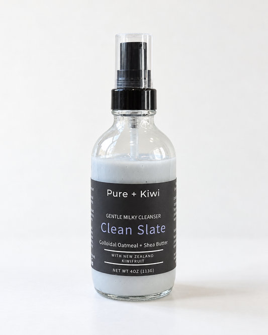 Pure + Kiwi Clean Slate Gentle Milky Cleanser in a 4 oz clear glass spray bottle with a black pump and clear cap, on a white background.